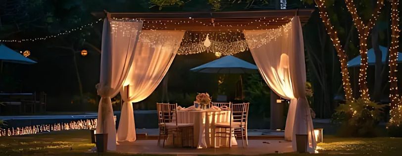 Planning a Backyard Wedding? Here’s How to Create the Perfect Vibe 3 backyard wedding dj. Romantic wedding dinner table under a softly lit pergola with sheer curtains