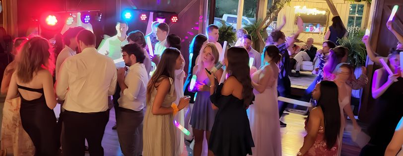 Michigan wedding guests dancing under vibrant DJ lighting – questions to ask wedding DJ Michigan.