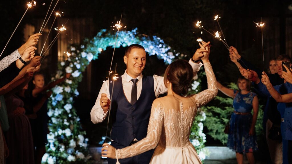 Wedding DJ cost in Michigan reflected in a beautifully coordinated sparkler send-off celebration